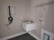 Functional laundry room with utility sink, shelving, and modern fixtures at 413 Shannon Estates Ct, Plant City, FL 33563