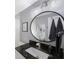 Modern bathroom with a large vanity mirror and granite countertop at 4304 Woodfield Ave, Holiday, FL 34691