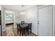 Bright dining area with a table and four chairs, and view into a bedroom at 4304 Woodfield Ave, Holiday, FL 34691