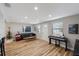 Spacious living area featuring hardwood floors, stylish furniture, and a Christmas tree at 4304 Woodfield Ave, Holiday, FL 34691