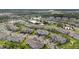 Aerial view showing a community with houses, ponds, and walking paths at 4663 Almada Ln, Wesley Chapel, FL 33543