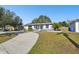 Newly renovated house with a long driveway and mature trees at 5239 22Nd N Ave, St Petersburg, FL 33710