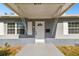 White front door with a gray frame and covered entryway at 5239 22Nd N Ave, St Petersburg, FL 33710