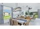 Bright dining room with a farmhouse table and access to the backyard at 5803 Laurelcrest Gln, Palmetto, FL 34221