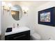 Updated bathroom with a modern vanity, toilet, and oval mirror at 6500 Sunset Way # 418, St Pete Beach, FL 33706