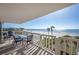 Balcony with table and chairs overlooking the ocean at 6500 Sunset Way # 418, St Pete Beach, FL 33706