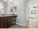 Bathroom with dark wood vanity, granite countertop and view of bedroom at 803 Bella Verde Pl, Ruskin, FL 33573