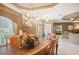 Bright dining room with a chandelier and views to the living room at 8933 Crescent Forest Blvd, New Port Richey, FL 34654