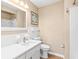 Bathroom with white vanity, tiled walls, and updated fixtures at 897 Imperial Dr, Largo, FL 33771