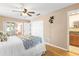 Bedroom featuring wood floors, ceiling fan, and ensuite access, offering comfort and privacy at 897 Imperial Dr, Largo, FL 33771