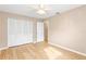 Bright bedroom with closet and wood-look flooring at 897 Imperial Dr, Largo, FL 33771