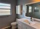 Clean bathroom with white vanity, toilet, and a large mirror at 903 Mook St, Brandon, FL 33510