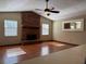 Living room with hardwood floors, brick fireplace and large windows at 903 Mook St, Brandon, FL 33510