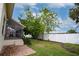 Spacious backyard with screened patio, lush landscaping, and brick pavers at 107 17Th St, Belleair Beach, FL 33786