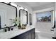 Modern bathroom with double vanity, marble accents, and a bathtub at 107 17Th St, Belleair Beach, FL 33786