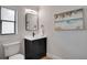 Stylish bathroom with dark vanity and beachy art at 107 17Th St, Belleair Beach, FL 33786