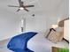 Spacious bedroom with ensuite bathroom access and a blue comforter at 107 17Th St, Belleair Beach, FL 33786