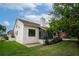 View of the house exterior showing a screened porch and landscaping at 107 17Th St, Belleair Beach, FL 33786
