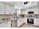 Modern kitchen with stainless steel appliances and white cabinets at 107 17Th St, Belleair Beach, FL 33786