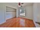 Well-lit bedroom with wood-look tile and a large closet at 11 Leaning Palm Ct, Plant City, FL 33563