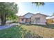 One-story home showcasing a peach-colored exterior and a neat front yard at 11 Leaning Palm Ct, Plant City, FL 33563