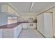 Kitchen with pink countertops and white appliances at 11 Leaning Palm Ct, Plant City, FL 33563