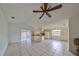 Open living area with tile floors and access to kitchen at 11 Leaning Palm Ct, Plant City, FL 33563