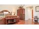 Spacious bedroom with wood floors and a large armoire at 12055 Gandy N Blvd # 231, St Petersburg, FL 33702