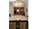 Spacious dining room with large table, chandelier, and view into kitchen at 12055 Gandy N Blvd # 231, St Petersburg, FL 33702