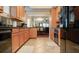 Open concept kitchen with wood cabinets and black appliances at 12055 Gandy N Blvd # 231, St Petersburg, FL 33702