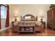 King-size bed with wooden frame in a spacious main bedroom with hardwood floor at 12055 Gandy N Blvd # 231, St Petersburg, FL 33702