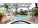 Relaxing pool and hot tub area with pergola and lounge chairs at 12055 Gandy N Blvd # 231, St Petersburg, FL 33702