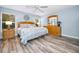 Spacious bedroom with wood furniture and access to the patio at 12132 Arron Ter, Trinity, FL 34655