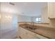 Kitchen features granite countertops and white cabinetry at 1400 Gandy N Blvd # 715, St Petersburg, FL 33702