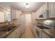 White kitchen with granite countertops at 1400 Gandy N Blvd # 715, St Petersburg, FL 33702