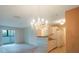 Living room with chandelier and view of kitchen at 1400 Gandy N Blvd # 715, St Petersburg, FL 33702