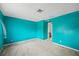 Simple bedroom with teal walls and access to hallway at 1409 Ne 49Th Ne Ave, St Petersburg, FL 33703
