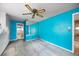 Bedroom with teal walls, mirrored wall, and access to bathroom at 1409 Ne 49Th Ne Ave, St Petersburg, FL 33703