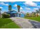Blue house with driveway, garage, and landscaped lawn at 1409 Ne 49Th Ne Ave, St Petersburg, FL 33703