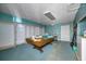 Basement game room with a pool table and storage at 1409 Ne 49Th Ne Ave, St Petersburg, FL 33703