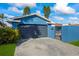 Attached garage with dark-colored door and gated entry at 1409 Ne 49Th Ne Ave, St Petersburg, FL 33703