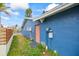 Side view of house showing pink door and utilities at 1409 Ne 49Th Ne Ave, St Petersburg, FL 33703