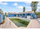 Green pool in need of cleaning; patio and house visible at 1409 Ne 49Th Ne Ave, St Petersburg, FL 33703