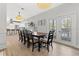 Bright dining room features a large table with seating for eight and hardwood floors at 1410 Poinsettia Ave, Tarpon Springs, FL 34689