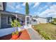 Inviting front entrance with screened porch, landscaping, and walkway at 1415 Yale Dr, Holiday, FL 34691