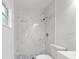 Updated bathroom with a marble shower and white toilet at 14915 Gentilly Pl, Tampa, FL 33624