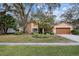 House exterior with landscaping and a two-car garage at 16811 Rolling Rock Dr, Tampa, FL 33618