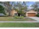 Attractive single-story house with mature landscaping and a two-car garage at 16811 Rolling Rock Dr, Tampa, FL 33618