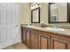 Bathroom with double sinks, granite countertop, and ample cabinet space at 17403 Estes Rd, Lutz, FL 33548