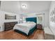 Spacious bedroom with teal bed frame and wood floors at 18236 Holland House Loop, Land O Lakes, FL 34638